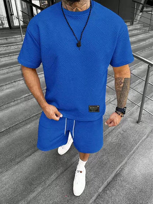 Casual blue short-sleeve outfit featuring a textured design, paired with matching shorts, ideal for summer wear. Part of our men's clothing and accessories collection.