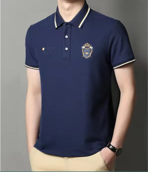 Model wearing navy blue embroidered short-sleeved polo shirt, breathable, casual and professional style by AURORE LUXURE. Stylish summer look.