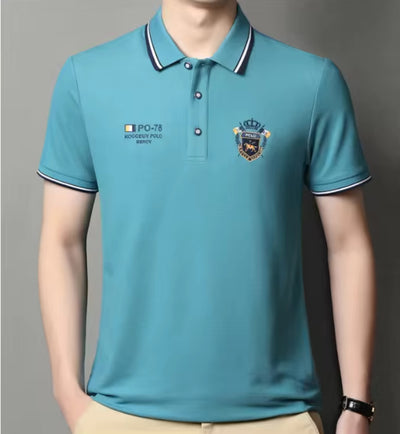 Model showcasing teal embroidered short-sleeved polo shirt, breathable, casual and professional style by AURORE LUXURE. Great for casual outings.